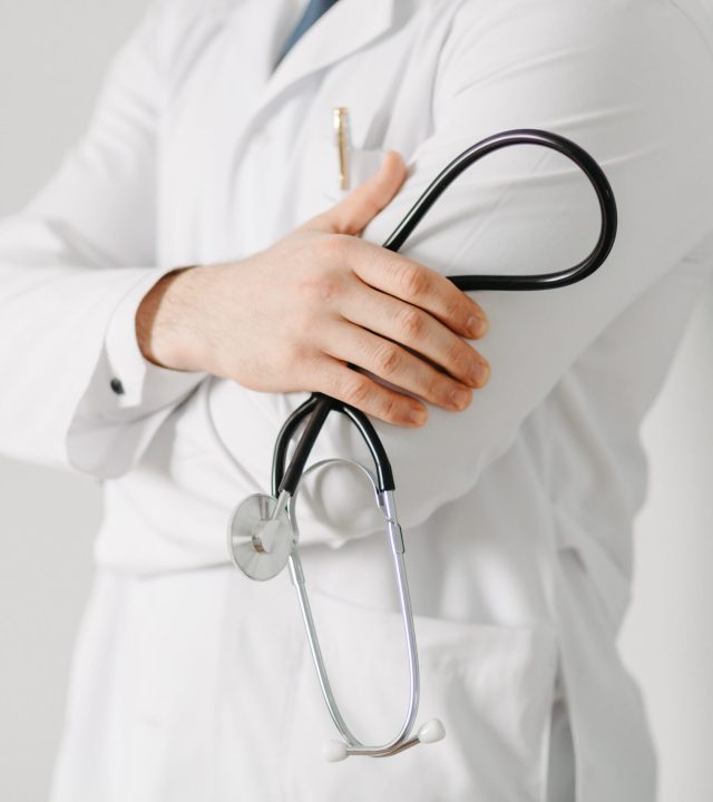 portrait of a friendly doctor. isolated on gray